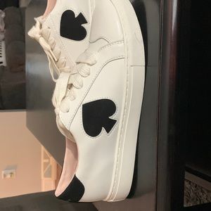 Kate Spade fez black and white sneakers.